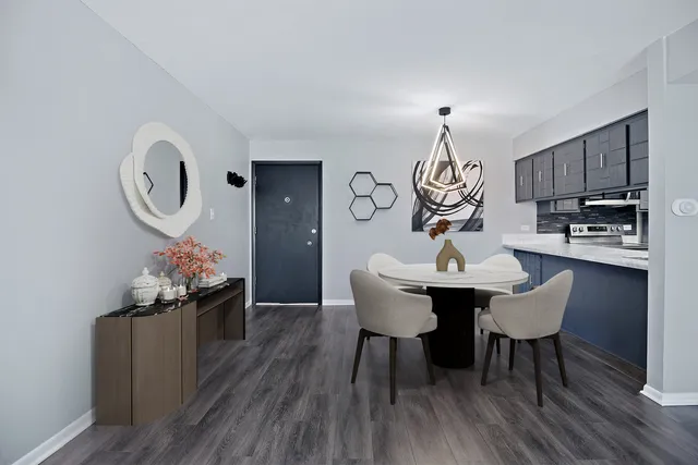 a view of a kitchen area with furniture and wooden floor