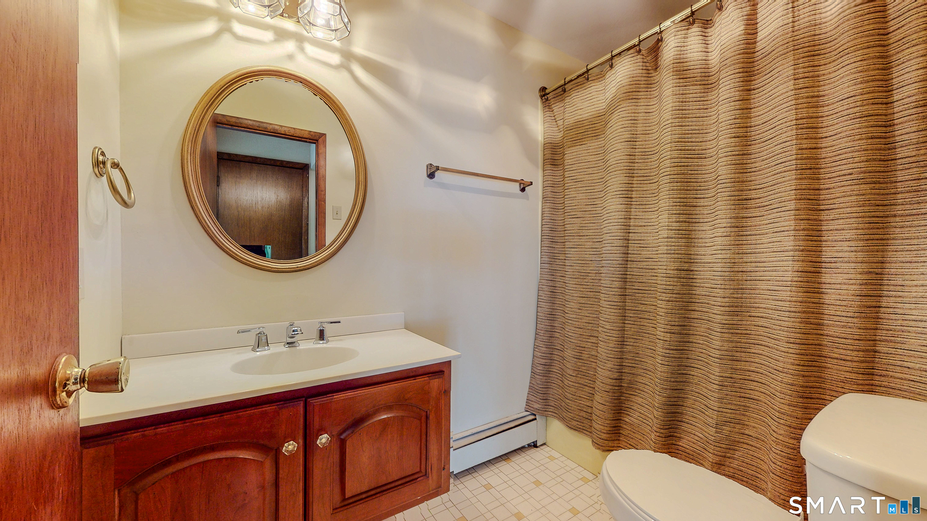 133 Chambers Road Danbury, CT 06811 - Photo 10 of 30 a bathroom with a sink a mirror a toilet and a sink