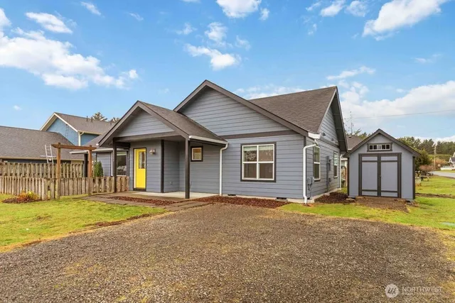 a backyard of a house with table and chairs