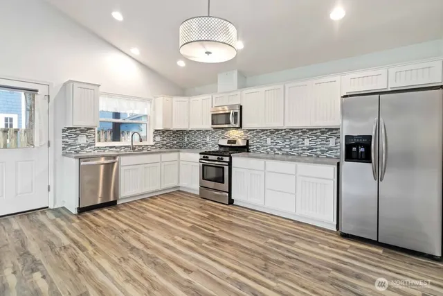 a kitchen with a sink and a stove top oven