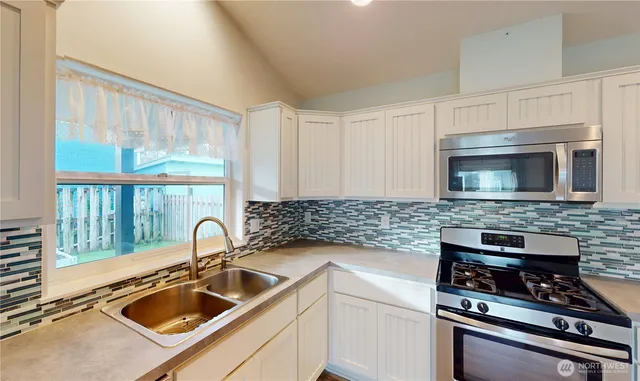 a kitchen with a sink and a stove