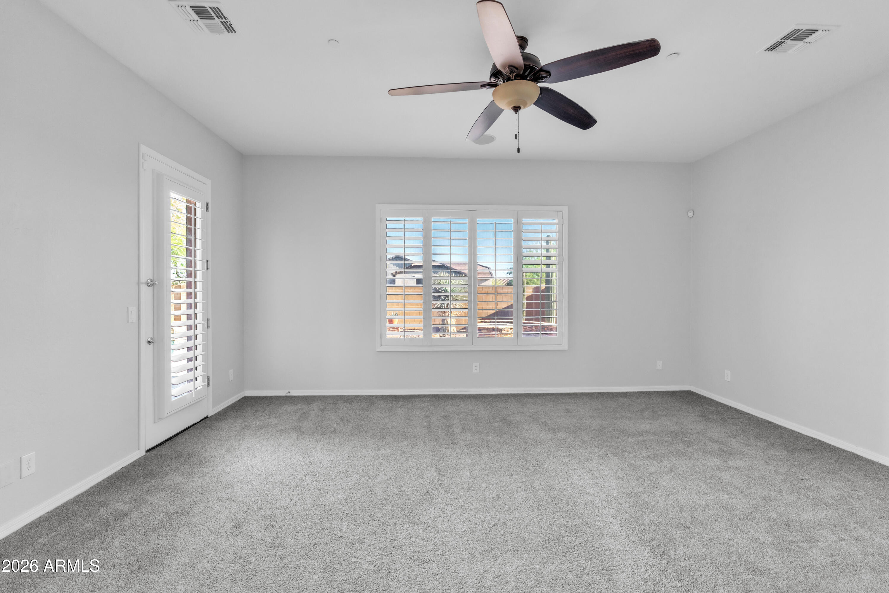 1615 West Red Fox Road Phoenix, AZ 85085 - Photo 27 of 64 wooden floor in an empty room with a window