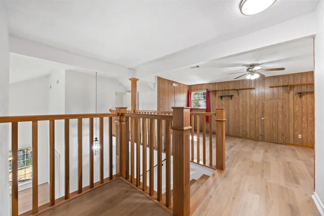 a view of hallway with wooden floor