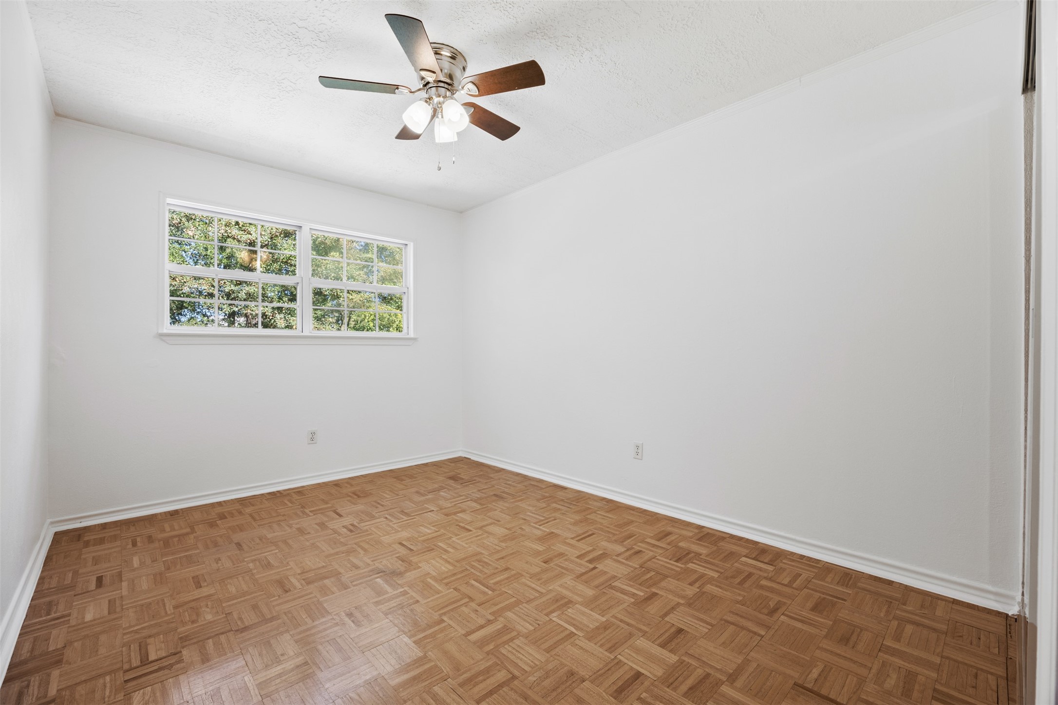 12 Dewthread Court Spring, TX 77380 - Photo 19 of 24 an empty room with a window and a ceiling fan
