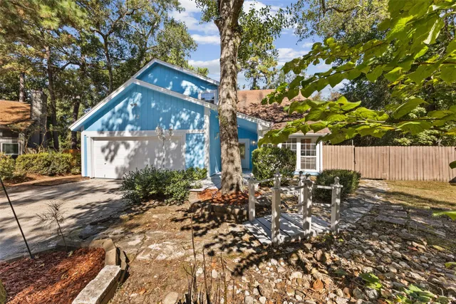 a backyard of a house with table and chairs