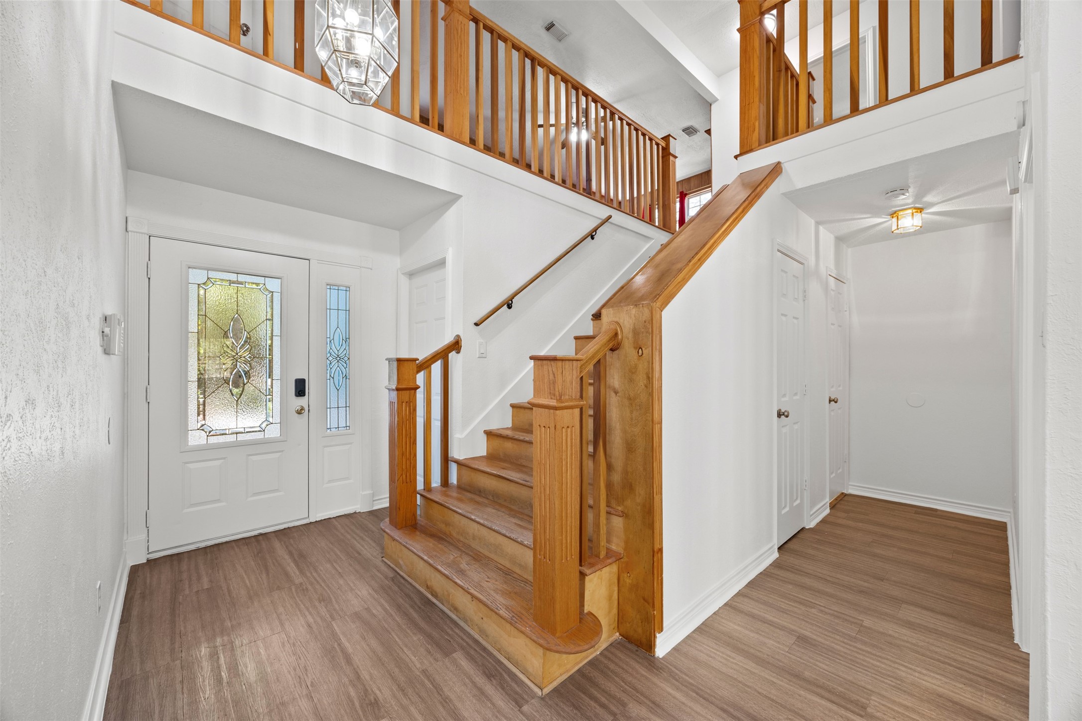 12 Dewthread Court Spring, TX 77380 - Photo 3 of 22 a view of front door with wooden floor and stairs