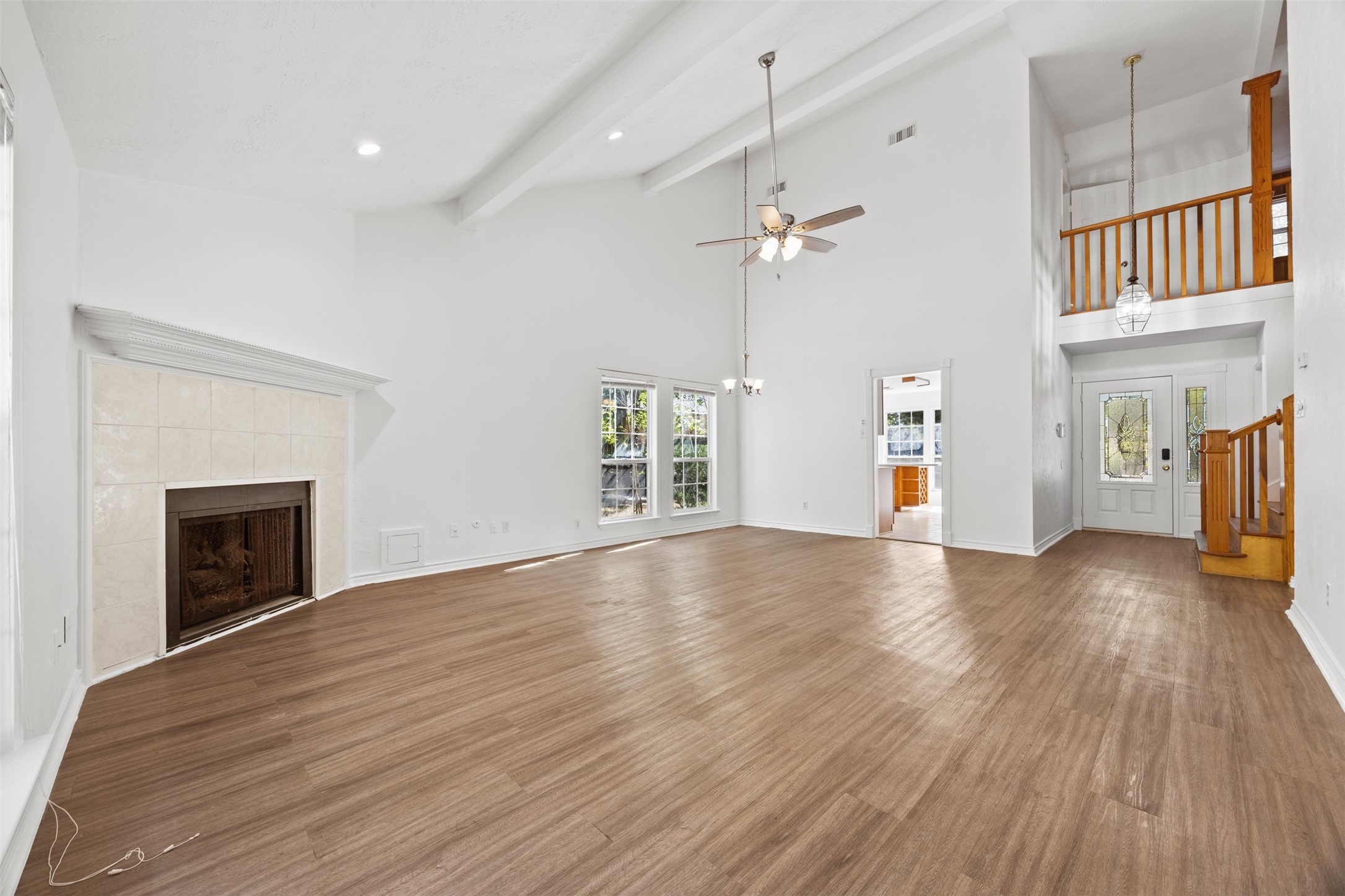 12 Dewthread Court Spring, TX 77380 - Photo 4 of 22 a view of an empty room with wooden floor fireplace and a window