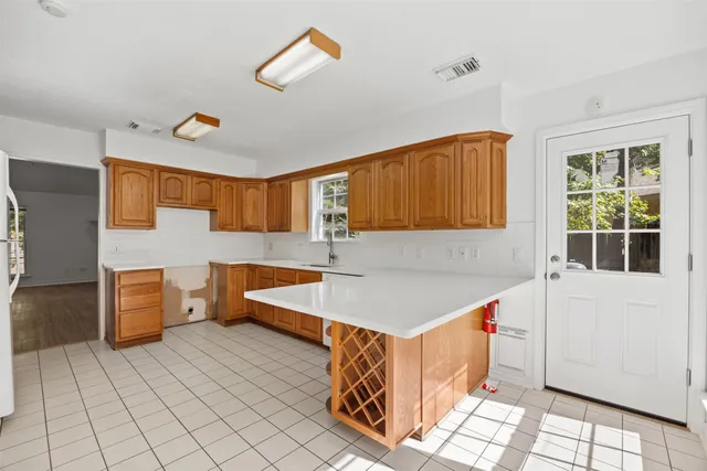 a kitchen with a sink a counter top space and cabinets