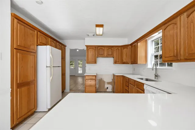 a kitchen with stainless steel appliances granite countertop a refrigerator and a sink
