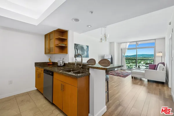 a kitchen with a stove and a wooden floor