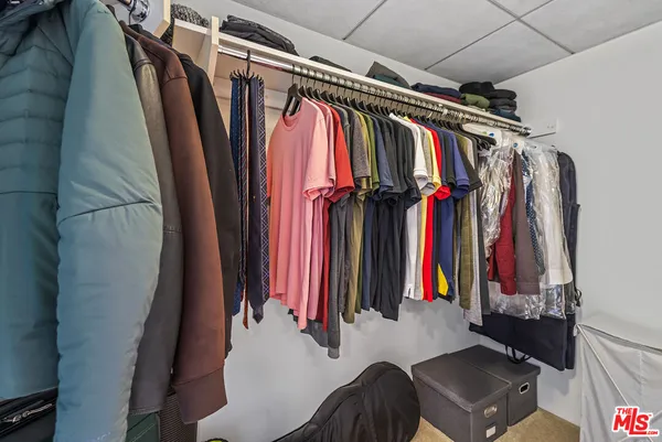 a view of a hallway with wooden floor and closet