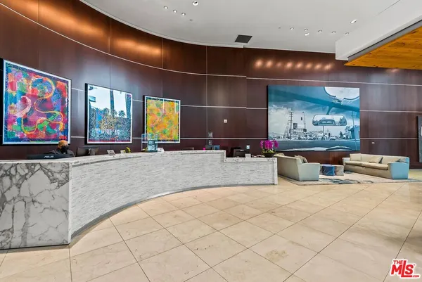 a living room with furniture and flowers