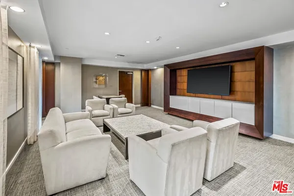 a view of a livingroom with furniture and a flat screen tv