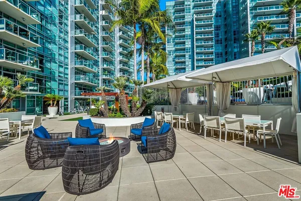 a swimming pool with outdoor seating and yard