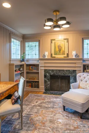 a living room with furniture a window and a fireplace