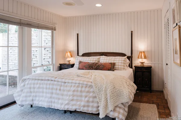 a bedroom with a bed and large window