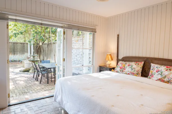 a bedroom with a bed and a large window