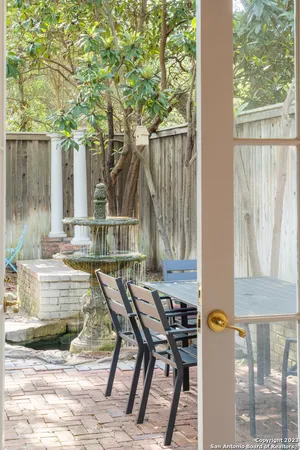 a view of a house with backyard and sitting area