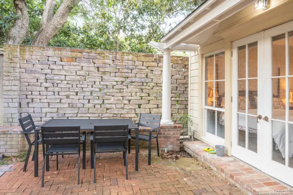 a backyard of a house with table and chairs