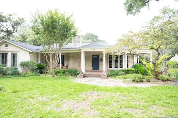 a view of a house with a yard and plants