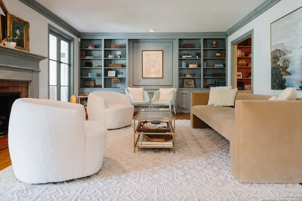 a living room with furniture and large window