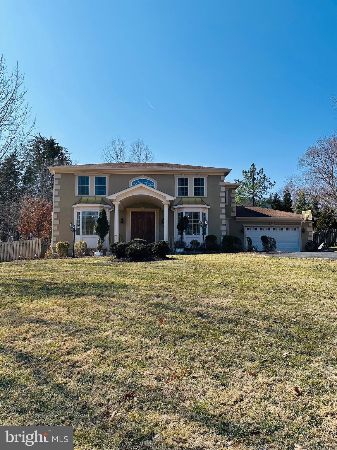 6413 Divine Street McLean, VA 22101 - Photo 1 of 60 a front view of a house with a garden