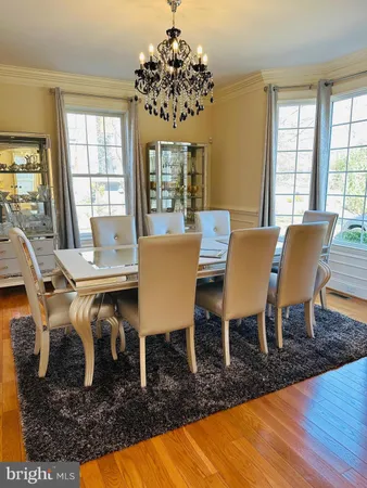 a kitchen with stainless steel appliances granite countertop a sink a stove and a wooden floors