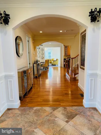 a large kitchen with stainless steel appliances granite countertop a stove and a wooden floors
