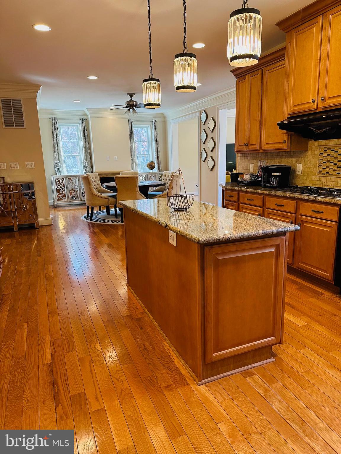 6413 Divine Street McLean, VA 22101 - Photo 19 of 60 a kitchen with stainless steel appliances granite countertop a sink a stove and a wooden floors