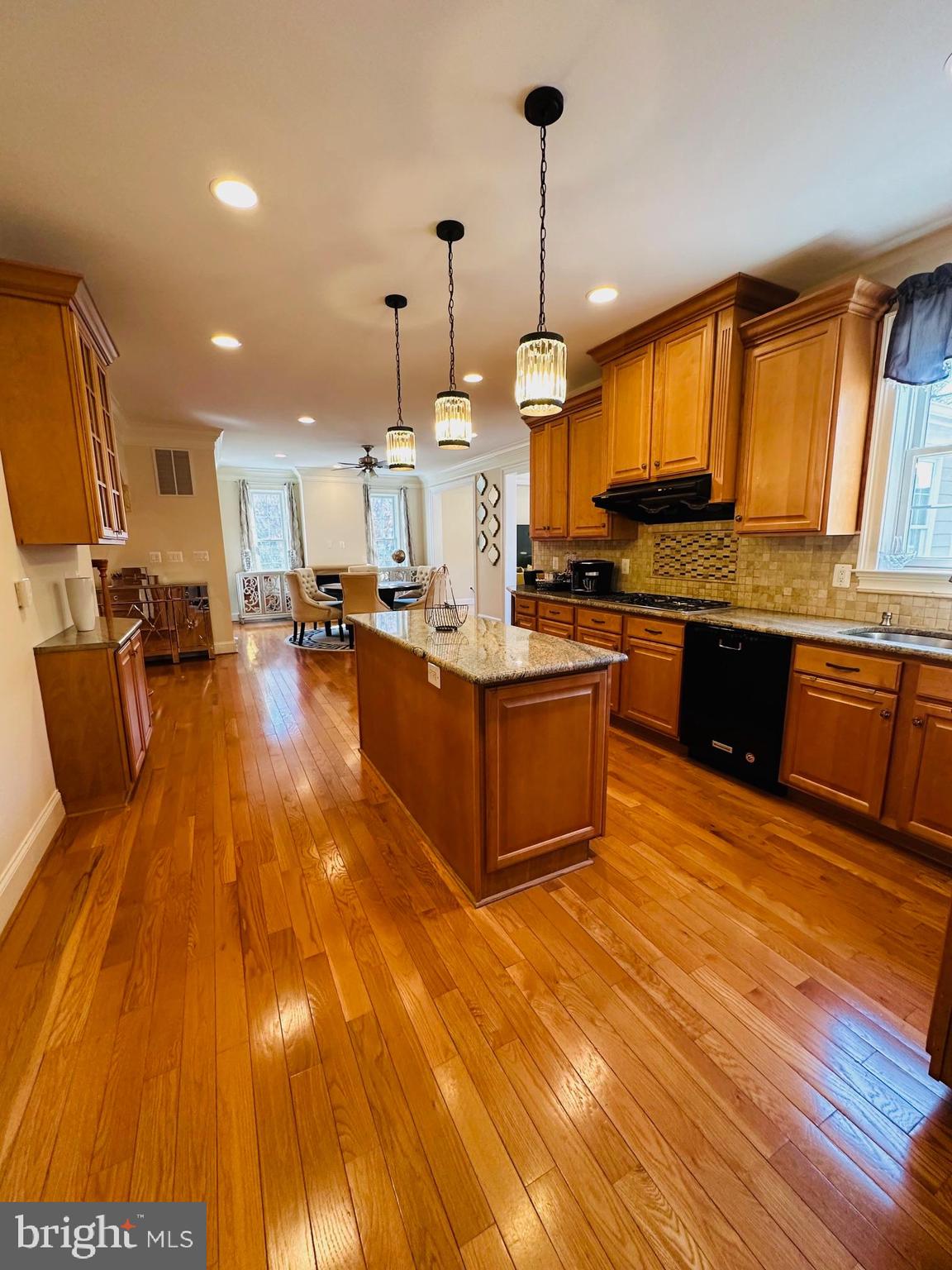 6413 Divine Street McLean, VA 22101 - Photo 20 of 60 a large kitchen with stainless steel appliances granite countertop a stove and a wooden floors