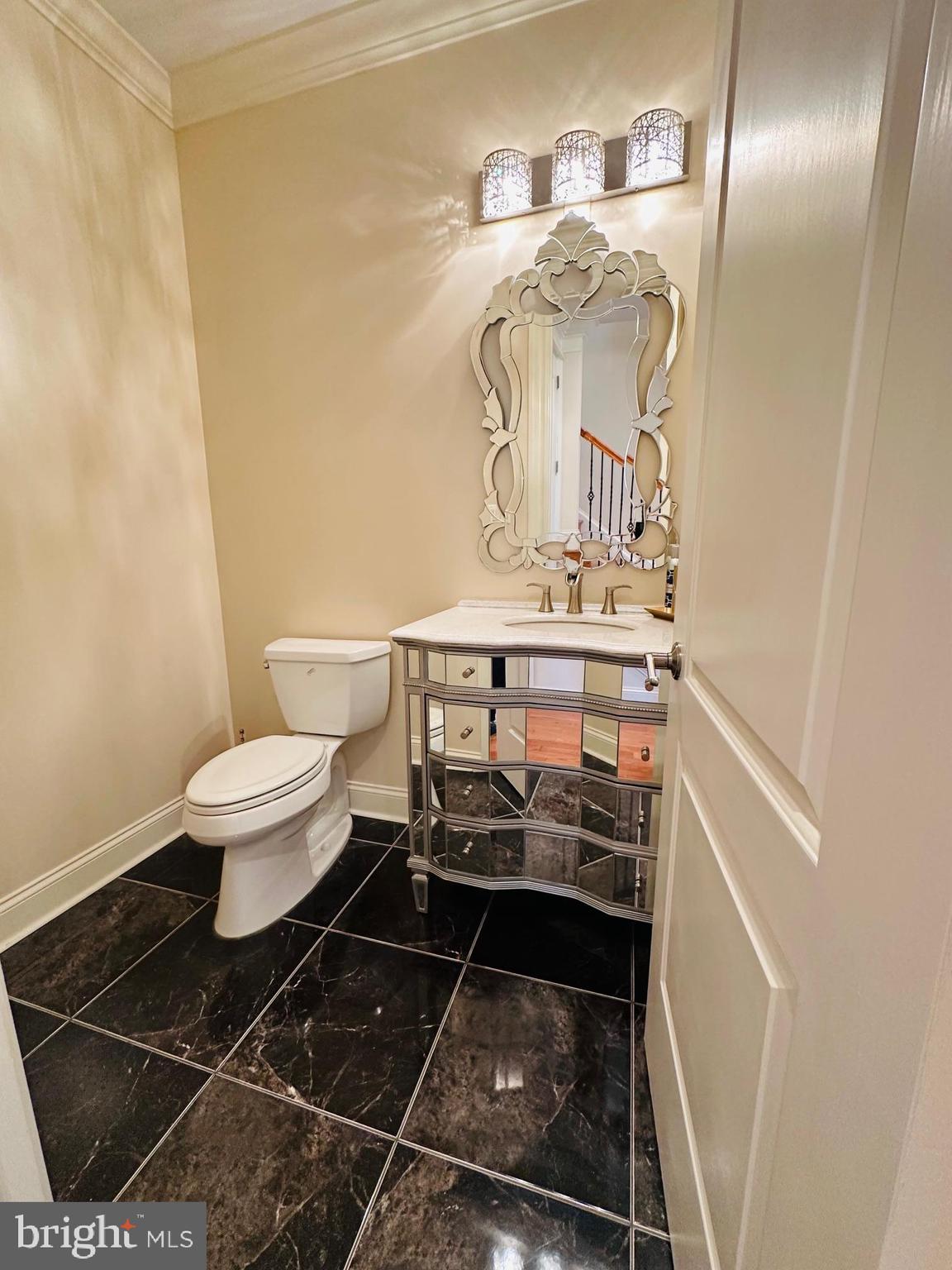 6413 Divine Street McLean, VA 22101 - Photo 26 of 60 a bathroom with a toilet and a mirror
