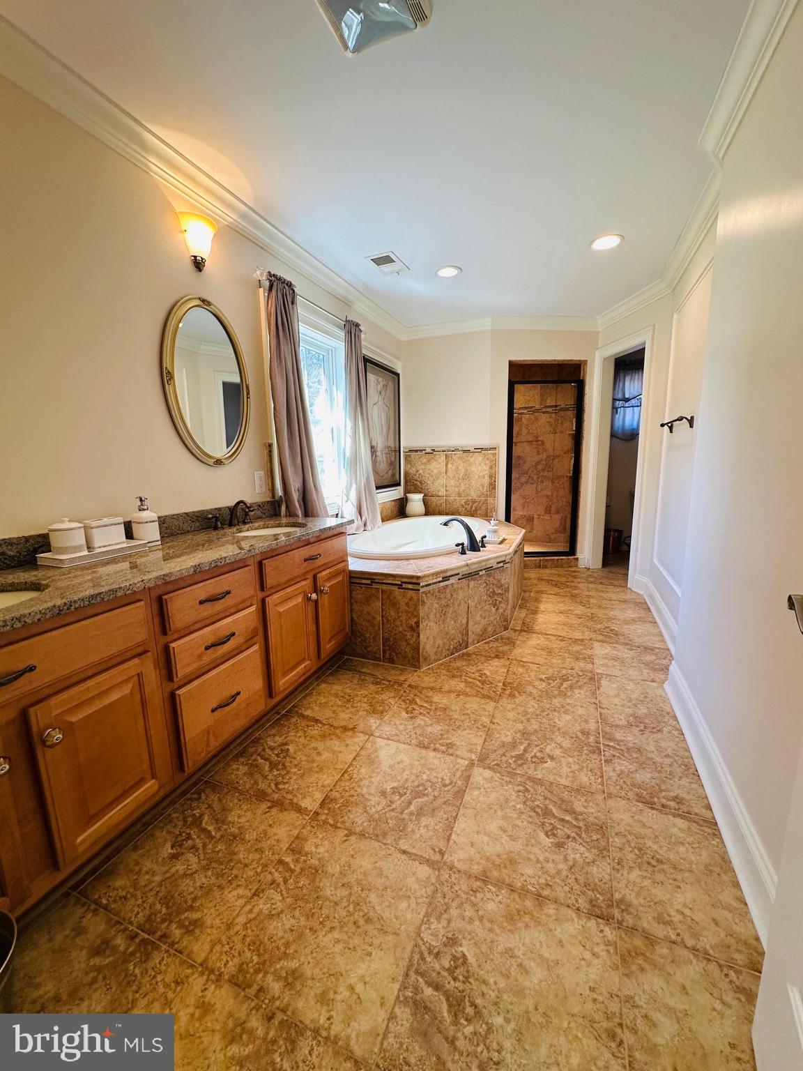 6413 Divine Street McLean, VA 22101 - Photo 33 of 60 a large bedroom with a large bed and a dresser
