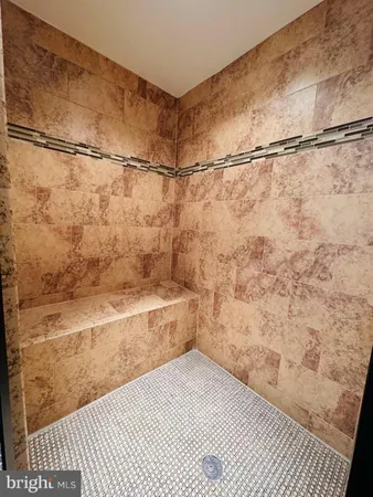 a bathroom with a toilet mirror vanity and sink