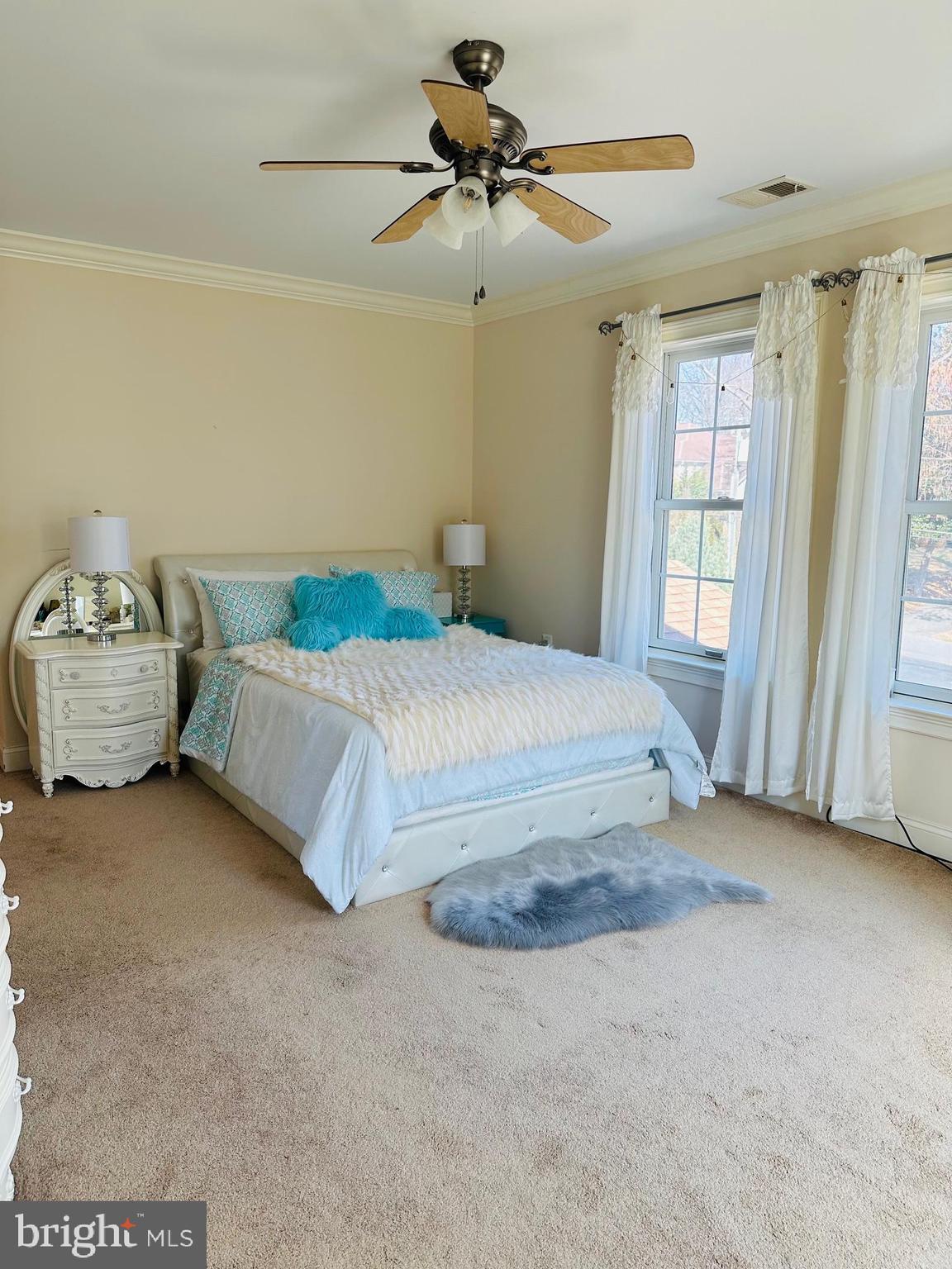 6413 Divine Street McLean, VA 22101 - Photo 38 of 60 a bedroom with a bed and a chandelier