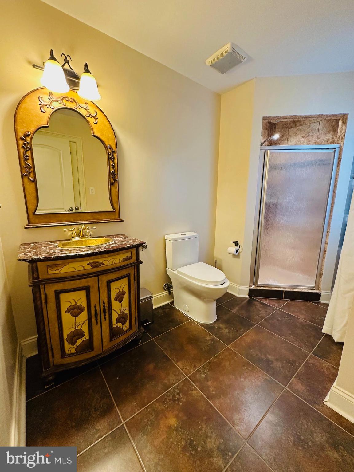 6413 Divine Street McLean, VA 22101 - Photo 42 of 60 a bathroom with a toilet mirror vanity and sink