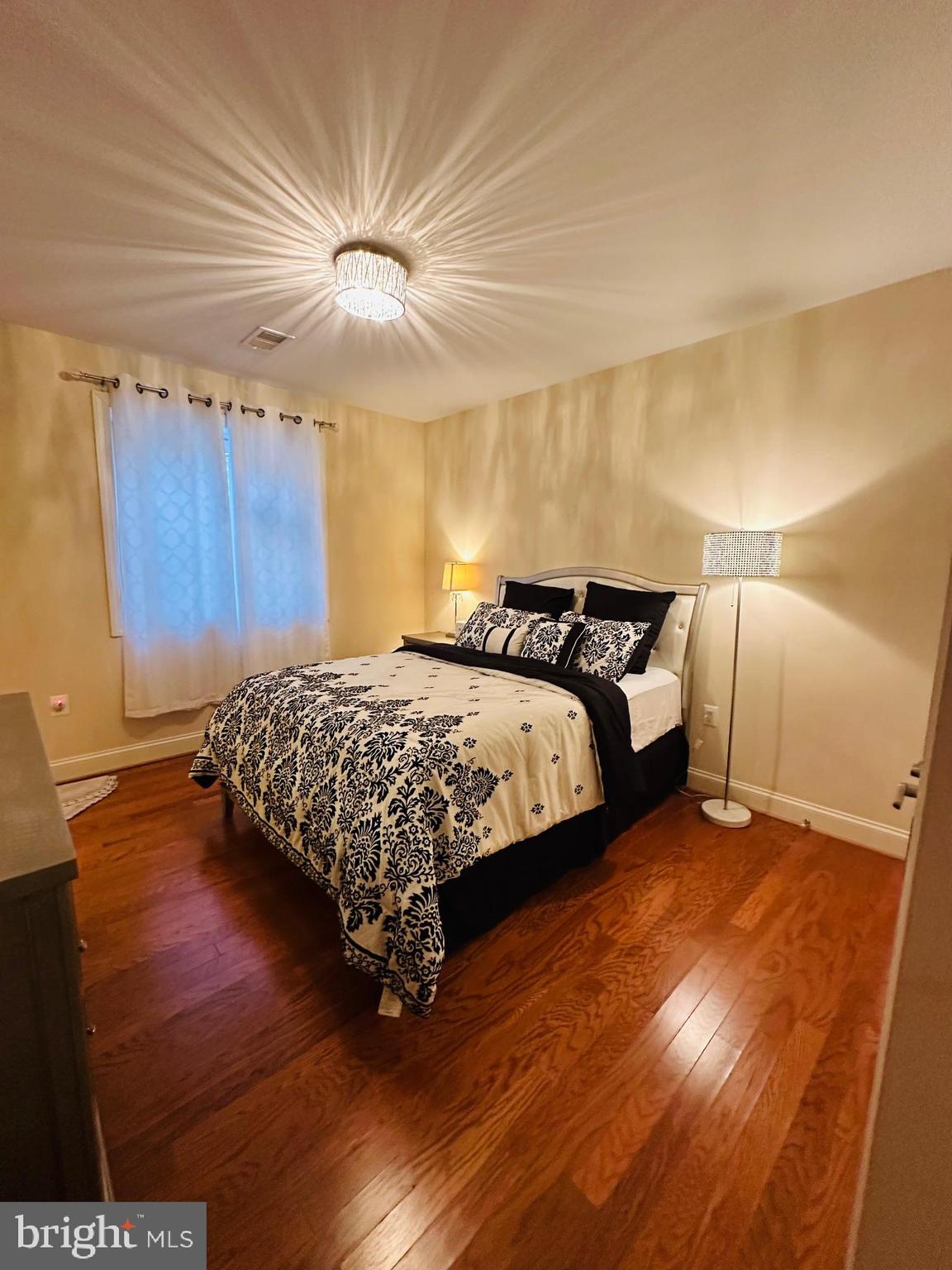 6413 Divine Street McLean, VA 22101 - Photo 46 of 60 a bedroom with a bed and a night stand