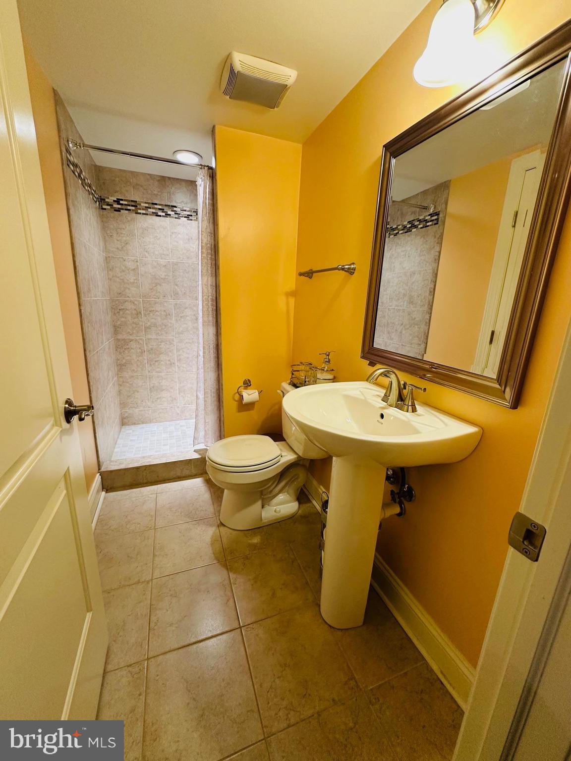 6413 Divine Street McLean, VA 22101 - Photo 47 of 60 a bathroom with a sink toilet and shower