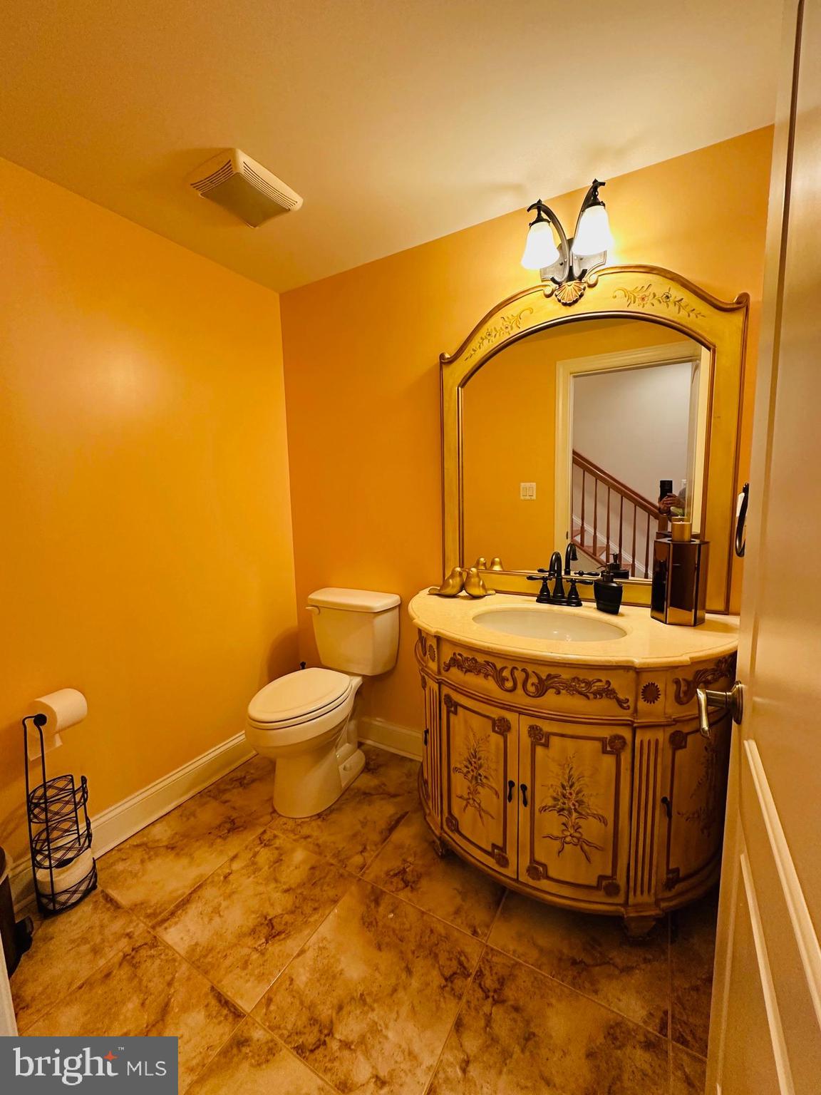 6413 Divine Street McLean, VA 22101 - Photo 51 of 60 a bathroom with a granite countertop sink mirror vanity and toilet