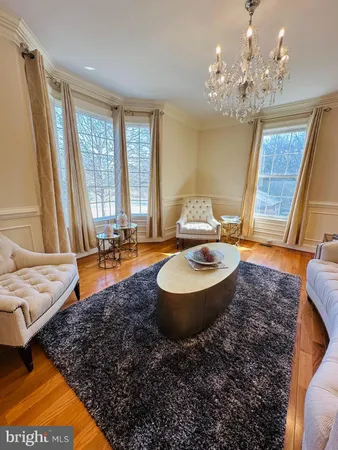 a large kitchen with stainless steel appliances granite countertop a stove and a wooden floors