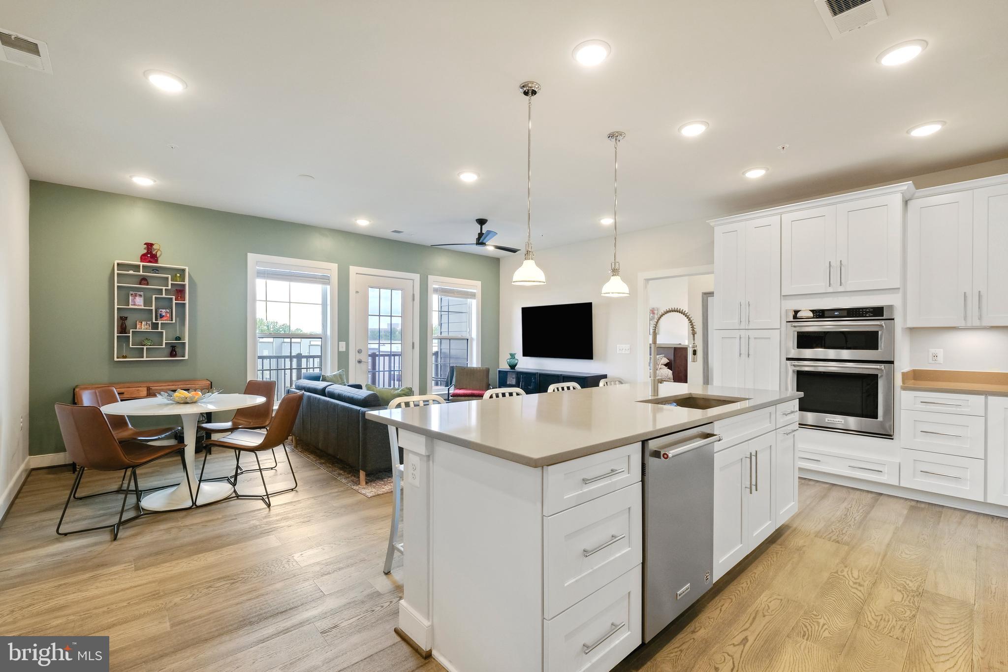 a large white kitchen with a stove and white cabinets