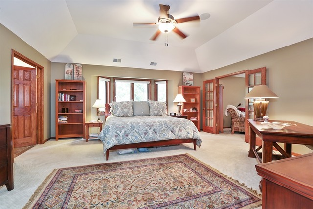 9032 Wolf Road Willow Springs, IL 60527 - Photo 12 of 25 a living room with a bed and a bookshelf with wooden floor