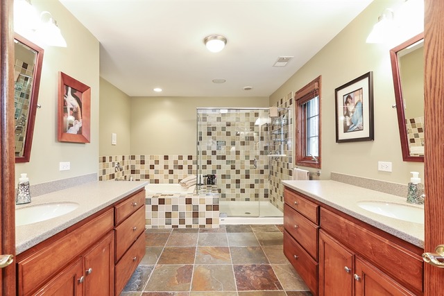 9032 Wolf Road Willow Springs, IL 60527 - Photo 14 of 25 a bathroom with a double vanity sink toilet mirror and bathtub