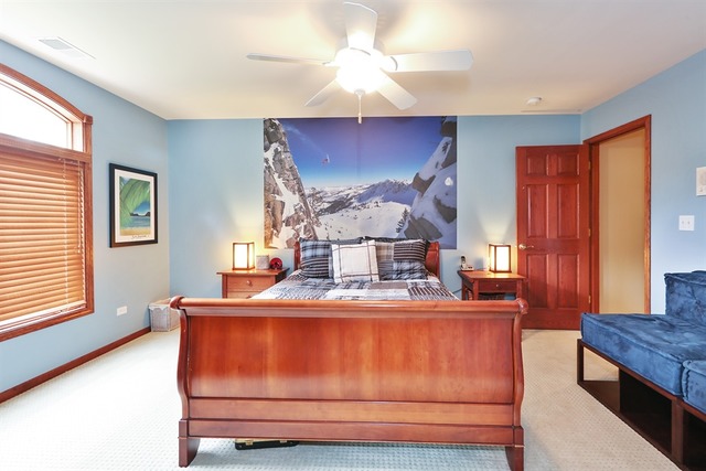 9032 Wolf Road Willow Springs, IL 60527 - Photo 16 of 25 a room with a bed and a chandelier