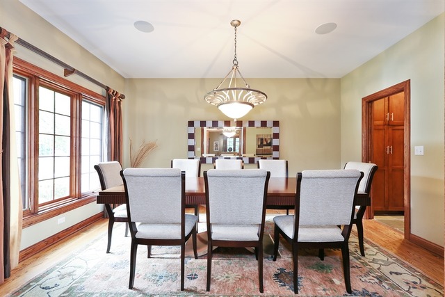 9032 Wolf Road Willow Springs, IL 60527 - Photo 5 of 25 a dining room with furniture a chandelier and wooden floor