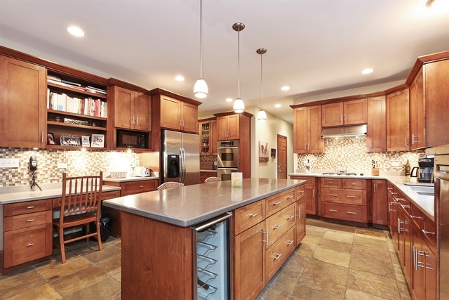 9032 Wolf Road Willow Springs, IL 60527 - Photo 7 of 25 a large kitchen with kitchen island a sink a center island stainless steel appliances and a cabinets