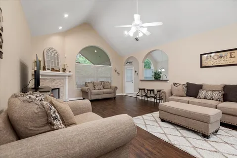 a living room with furniture a fireplace and chandelier