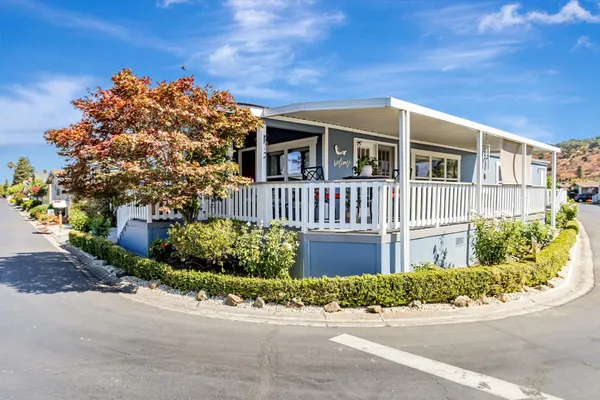 a front view of a house with a garden