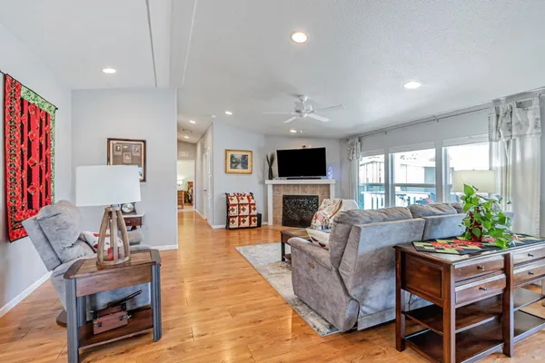 a living room with furniture a fireplace and a flat screen tv