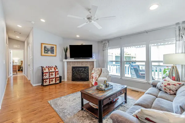 a living room with furniture a fireplace and a flat screen tv