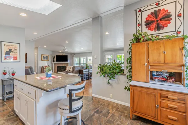 a kitchen with stainless steel appliances granite countertop a refrigerator and a stove top oven